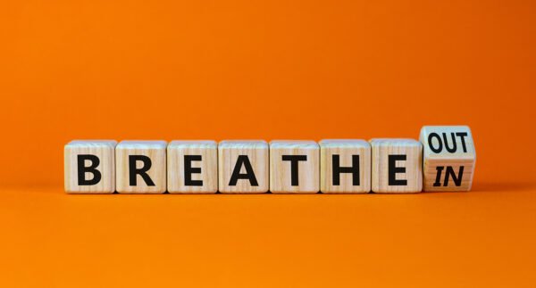 Breathe In And Out Symbol. Turned A Wooden Cube And Changed Word